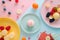 Abstract food background with ingredients such as fruits sweets and berries in pastel colors.