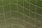 Abstract football net against green grass.