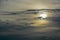 The abstract formation and texture of the clouds over and around the sun. Above the Gulf of Mexico in florida