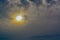 The abstract formation and texture of the clouds over and around the sun. Above the Gulf of Mexico in florida