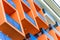 Abstract fragment of modern architecture, facade and orange balconies, close-up