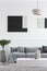 Abstract geometric black and paintings on white wall of trendy living room interior