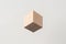 Abstract geometric real wooden cube with surreal layout on white background