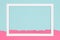 Abstract geometrical pastel blue and pink colored paper flat lay background. Minimalism template with empty picture frame.
