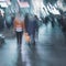 Abstract girl in a bright orange jacket back to us, dark blurred background, city street in evening, pedestrian street