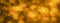 Abstract glitter gold and yellow bokeh glow in the dark on black background, banner panoramic horizontal overhead for decorating a