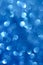 Abstract glittering cobalt blue bokeh background defocused