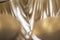 Abstract golden background pattern macro close-up of silver and golden metal surface with shiny reflections and harmonic shapes