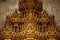 Abstract golden Buddha Statues on granite wall, Golden Temple Entrance Arches