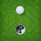 Abstract golf sport background of golf ball and golf hole on green grass background.