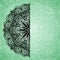 Abstract green background with black lacy mandala pattern