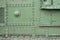 Abstract green industrial metal textured background with rivets and bolts