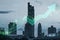 Abstract growing green candlestick arrow on blurry city background. Financial growth, market and trade conce