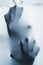 Abstract hands, human arm inside fabric, toned blue