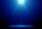 Abstract image of blue lighting flare on the floor stage.