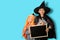 The abstract image of the child in the Halloween costume holds the empty blackboard. the concept of Halloween, festival, October,