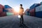 The abstract image of engineer standing in the container yard during sunrise. the concept of engineering, shipping, shipyard, busi