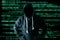 The abstract image of the hacker standing and the binary code image is backdrop. the concept of cyber attack, virus, malware, ille