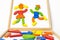 Abstract image of playing children made  from colored elements of wooden blocks or constructor set