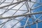 Abstract image of white steel struts and supports in front of a white-blue sky