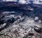Abstract imagery of aerial view of mountains, rugged terrain, and clouds