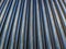 Abstract industrial close-up background of shiny cnc turned rods with linear perspective and selective focus