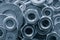 Abstract industrial textured metal background with many metal washers for bolts and screws close-up