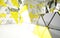 Abstract interior next to the walls and ceiling of an array of yellow and black prisms.