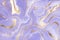 Abstract lavender liquid marbled watercolor background with golden lines and stains. Violet marble alcohol ink drawing