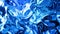 Abstract liquid background with wavy sparkling pattern on shiny glossy surface. Viscous blue fluid like surface of foil