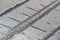 Abstract metal line barrier on stone surface closeup, technology diversity,