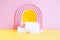 abstract minimalistic pink stage with two rectangular white podium on yellow, pink heart and fluffy ball.