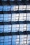 Abstract mirrored reflective geometric 3d background. Scales building. Blue reticulated facade