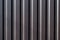 Abstract of monochrome metal blinds with a straight horizontal view, showing contrasting highlights and shadows
