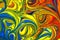 Abstract multicolored liquid paint swirls background