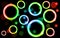 Abstract, multicolored, neon, shiny, bright, glowing circles, balls, bubbles, light spots with stars on a black background.