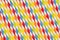 Abstract multicolored rainbow geometric striped background of beverage straw.