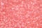 Abstract New Year coral bokeh background with shining defocus sparkles. Blurred glitters shimmering dust macro close up, copy