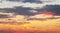 Abstract oil painting evening sky in beige and bright colors. Colored clouds. Contemporary art random paint strokes in warm colors