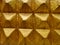 Abstract old golden brick wall textured background with triangular design