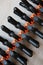 Abstract pattern from black and orange construction clamps. Clamping tools for carpentry work. Hand tools for needlework
