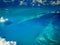 Abstract pattern of blues swirls of underwater reefs aerial view of Caribbean islands