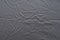 Abstract pattern of a gray crumpled bed sheet in bedroom. Gray wrinkled fabric texture rippled surface, Close up bed sheet in the