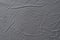 Abstract pattern of a gray crumpled bed sheet in bedroom. Gray wrinkled fabric texture rippled surface, Close up bed sheet in the