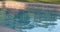 Abstract peaceful swimming pool water and deck in sun