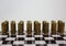 Abstract photo with metal brass gold gun bullets hubs on chessboard