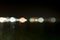 Abstract photo, street lights at night on the sea seen
