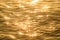 Abstract photo of surface water of sea or ocean at sunset time with golden light tone.