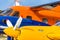Abstract picture of several historical small aircrafts, cut and depicted one behind the other, yellow, blue and orange airplane