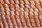 Abstract piles and packs of a new clay ceramic tiles to cover the roof of a Buddhist temple. Stack of new orange roof tiles in the